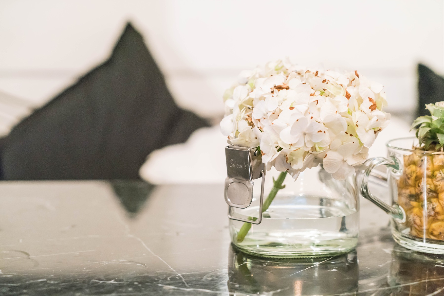 Flowers and glass in a softly lit interior